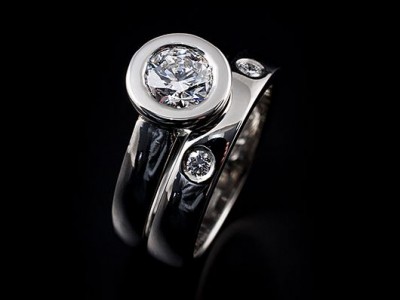 Platinum Round Brilliant Engagement Ring: 1.00ct F VS2 with a Matching Integrated Platinum Wedding Ring with 2 x 0.04ct F VS Round Brilliants Secret Set into Band.