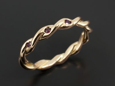 18kt Rose Gold Twist Wedding Ring with Secret Set Rubies.