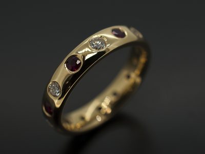 Round Brilliant Cut Diamond 0.44ct (7) & Round Brilliant Cut Rubies 0.53ct (7) Secret Set in 18kt Yellow Gold In an Eternity Ring Design