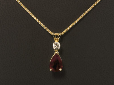 18kt Yellow Gold Claw Set Ruby and Diamond Drop Pendant, Pear Shape Ruby 1.05ct and Round Brilliant Cut Diamond 0.15ct F Colour VS Clarity Minimum, Split Bale Detail on a Spiga Chain