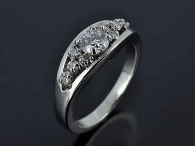 Round Brilliant 0.67ct E Colour VS1 Clarity with Multiple Round Brilliant Diamonds Claw Set in a Semi Tension Design.