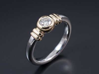 Round Brilliant 0.35ct G Colour VVS2 Clarity in a Two Tone 18kt Gold Rub Over Contemporary Setting.