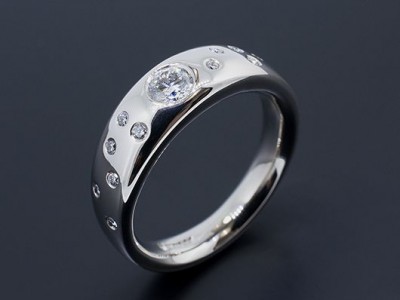 Palladium Halo Band Diamond Ring with Round Brilliants Secret Set into Band.