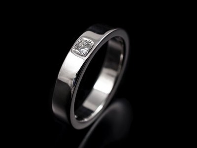 Ladies Platinum Wedding Ring with a 0.08ct F VS Princess Cut Diamond Secret Set into Band.