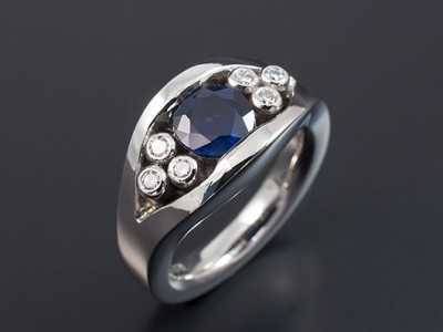 Platinum Semi Tension Set Design with a Round Sapphire 1.16ct and 6 x 2.0mm F VS Round Diamonds Total Weight 0.18ct.