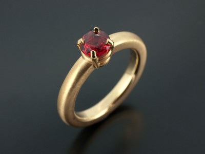 Blood Orange Sapphire 0.87ct in an 18kt Yellow Gold 4 Claw Setting with Halo Shaped Band