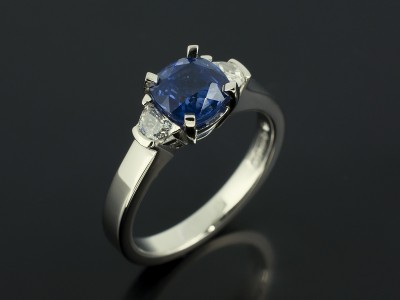 Cushion Cut Sapphire 1.51ct and Half Moon Cut Diamonds F Colour VS Clarity Min in a Platinum Claw Set Trilogy Design.