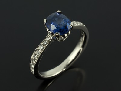 Cushion Cut Sapphire 1.65ct in Scroll Detail Setting with Pavé Set Diamond Shoulders in Platinum.