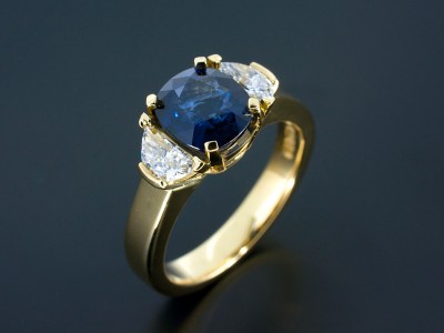 Cushion Sapphire 2.07ct with Half Moon Cut Diamonds 0.47ct Total in a 18kt Yellow Gold Trilogy Design.