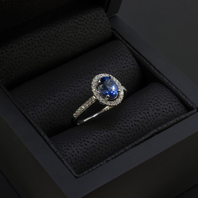 Oval Cut Sapphire 1.25ct with Round Brilliant Cut Diamonds 0.25ct Total in a Platinum Claw Set Halo Design.