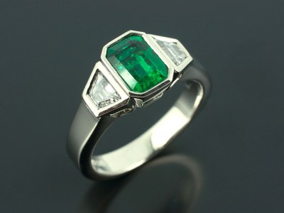 Emerald 1.36ct with Trapezium Step Cut Diamonds F Colour VS Clarity Min 0.38ct Total in a Palladium Rub Over Trilogy Design