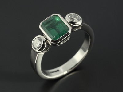 Emerald 1.50ct with 2 x Round Brilliant Cut Diamonds F SI Minimum 0.51ct Total in a Palladium Rub Over Trilogy Setting.