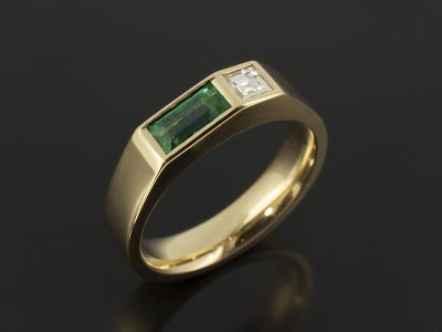 Baguette Cut Emerald 0.40ct with Carré Cut Diamond 0.17ct F VS in an 18kt Yellow Gold Rub Over Set Design.