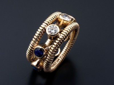 Ladies Diamond and Sapphire Ring, 9kt Yellow Gold with Coiled Band Detail, Round Sapphires and Round Brilliant Cut Diamonds in Rub over Settings