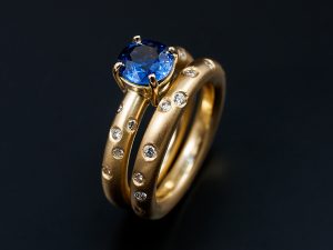 Round Ceylonese Sapphire 1.17ct in an 18kt Yellow Gold Setting with Scattered Secret Set Diamonds with a Matching Wedding Ring