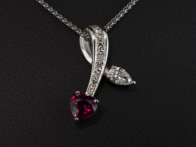 Platinum Pave and Claw Set Ruby and Diamond Heart Looped Design Drop Pendant, Heart Shaped Ruby 0.94ct and Pear Shaped Diamond 0.29ct F Colour SI Clarity with Round Brilliant Cut Diamonds 0.12ct Total Pavé Set into Loop, on Spiga Chain