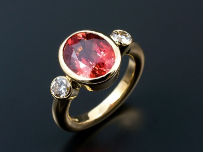 Oval 4.2ct Blood Orange Sapphire with 2 x 0.20ct F VS Round Brilliants in 18kt Yellow Gold Rub Over Settings