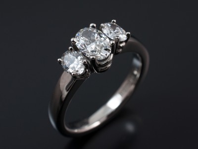 Ladies Trilogy Diamond Engagement Ring, Palladium Claw Set Design, Oval Cut Diamond Centre Stone 0.60ct, E Colour, VVS2 Clarity, Oval Cut Diamond Side Stones 2x 0.21ct, F Colour, VS Clarity