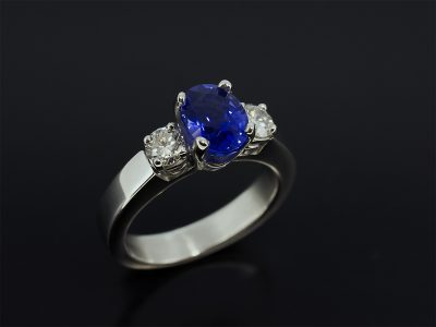 Oval Cut Sapphire 1.71ct With Two Round Brilliant Cut Diamonds 0.40ct (2) Claw Set in Platinum in a Trilogy Design