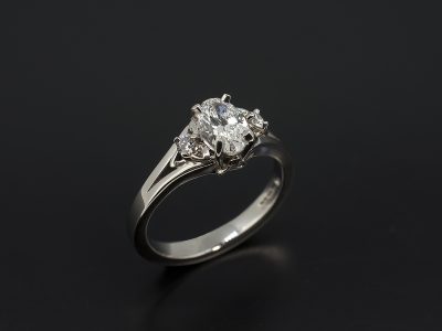 Ladies Trilogy Diamond Engagement Ring, Palladium Claw Set Celtic Design, Oval Cut Diamond Centre Stone 0.61ct, 2x Round Brilliant Cut Diamond Side Stones 0.08ct