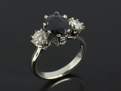 Oval Dark Sapphire 2.26ct with 2 x Round Brilliant Diamonds 0.83ct Total in Palladium Trilogy Setting.