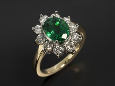 Oval Cut Emerald 1.66ct with Round Brilliant Cut Diamonds 0.85ct Total F Colour VS Clarity Min in an 18kt Yellow Gold and Platinum Cluster Setting.