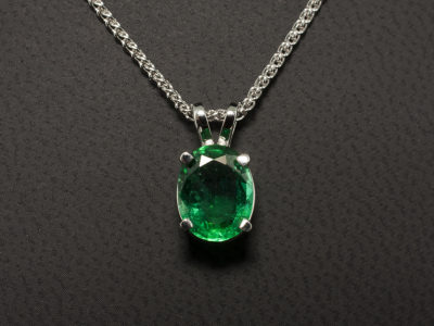 18kt White Gold Claw Set Emerald Solitaire Pendant, Oval Cut Zambian Emerald 1.56ct., Double Bale Detail on a Spiga Chain