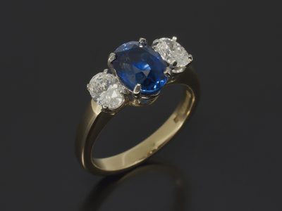 Oval Cut Sapphire 2.08ct Claw Set in Platinum with Round Brilliant Cut Diamond Sides, 0.66ct (2) on a 18kt Yellow Gold Shank