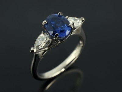 Oval Cut Ceylon Sapphire 1.68ct with Pear Cut Diamonds 0.47ct D Colour VS1 Clarity in a Palladium Trilogy Claw Set Design.