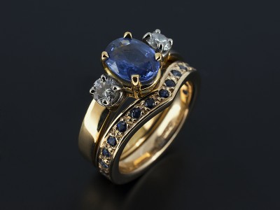 Oval Ceylon Sapphire 1.45ct with 2 x 0.15ct Round Brilliant Diamond Trilogy Design in 18kt Yellow Gold with Matching Pavé Set Sapphire Fitted Wedding Ring.