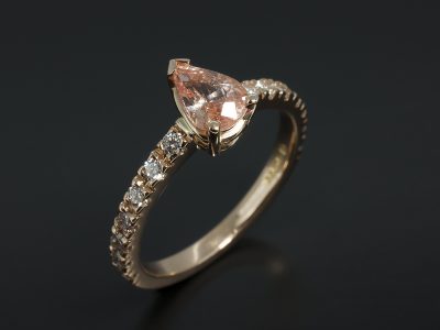 Pear Cut Peach Sapphire 0.91ct in an 18kt Rose Gold Diamond Claw Set Design.