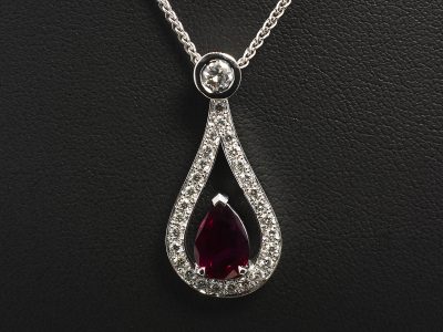 18kt White Gold Claw and Rub over Set Ruby and Diamond Drop Pendant, Pear Shape Siam Ruby 1.70ct with Rub over Set Round Brilliant Cut Diamond Bale 0.20ct and Pave Set Round Brilliant Cut Diamond Surround 0.30ct on an 18kt White Gold Spiga Chain