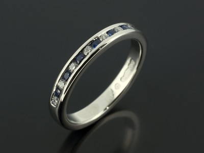 Platinum Round Diamond and Sapphire Channel Set Wedding Ring.