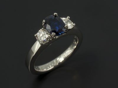 Oval Cut Sapphire 0.96ct and 2 x Round Brilliant Cut Diamonds 0.24ct Total F VS in a Platinum 4 Claw Set Trilogy Design.