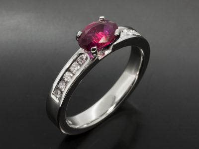 Platinum Four Claw & Channel Set Design Oval Cut Ruby, 1.02ct Round Brilliant Cut Diamonds, 0.19ct (10)