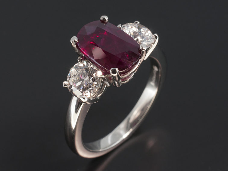 Platinum 4 claw set ruby and diamond trilogy design ring