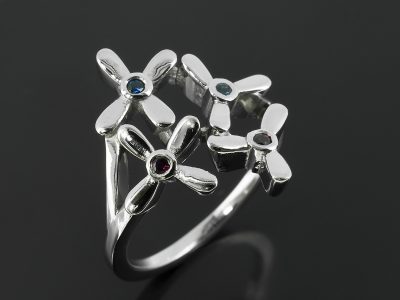 Platinum Petal Inspired Ring with Round Sapphires and Rubies.