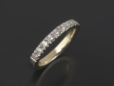 Platinum Claw Set Wedding / Eternity Ring with 0.27ct Round Brilliant Cut Diamonds and an 18kt Yellow Gold Inner Sleeve.