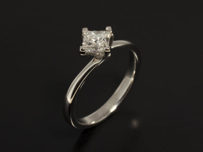 Ladies Solitaire Diamond Engagement Ring, Platinum NSEW Compass Set Twist Design, Princess Cut Diamond 0.63ct, D Colour, VS2 Clarity