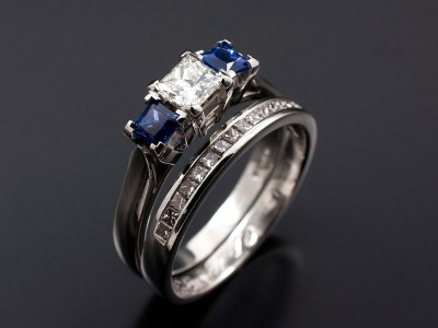 Princess Cut 0.40ct G VS1 with 2 x 0.25ct Square Sapphires in a Platinum 4 Claw Trilogy Setting with Matching Channel Set Platinum Wedding Ring.