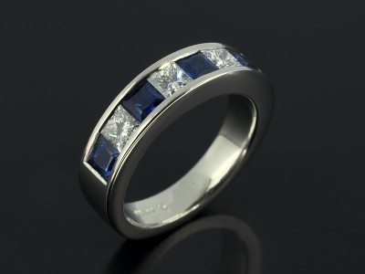Princess Cut Diamond and Sapphire Eternity Ring in a Channel Set Platinum Design.