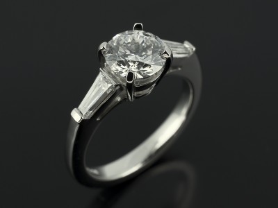 Round Brilliant 1.01ct D Colour SI1 Clarity EXEXEX with 0.40ct Tapered Baguettes in a Platinum Setting.