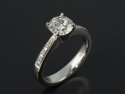 Round Brilliant 1.18ct G Colour SI2 Clarity in a 4 Claw Platinum Diamond Pavé Set Solitaire Design.