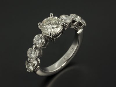 Round Brilliant 1.35ct with 1.87ct Total Side Diamonds in a Platinum Claw Set Design.