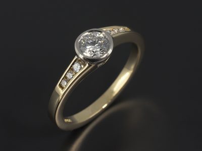 Round Brilliant 0.40ct D Colour SI1 Clarity EXEXEX in an 18kt White and Yellow Gold Rub Over Setting with Channel Set Twist Band.