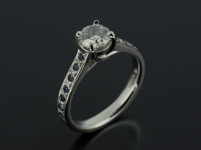 Platinum 4 Claw Design with Pavé Set Sapphire Shoulders Round Brilliant 0.64ct E SI1 EX Cut EX Polish EX Symmetry.