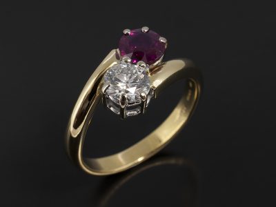 Round Brilliant 0.65ct E Colour VS1 Clarity and Round Brilliant 0.88ct Ruby in a 18kt White and Yellow Gold Claw Set Twist Design.