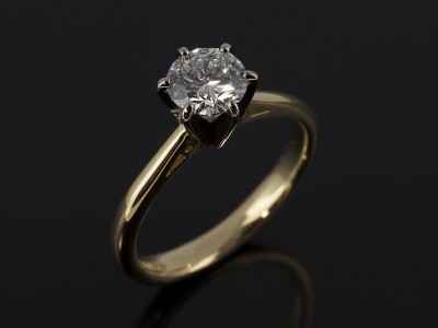 Round Brilliant 0.71ct E Colour VS2 Clarity EXEXEX in a 6 Claw 18kt Gold Solitaire Design with Scroll Shoulder Detail.