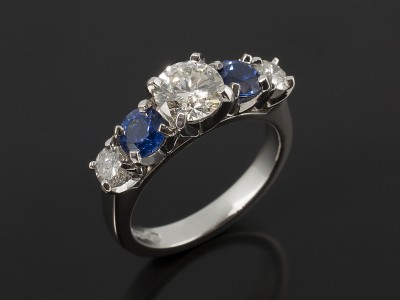 Round Brilliant Cut 0.73ct, 0.16ct and 0.15 with Round Brilliant Ceylon Sapphires 0.84ct Total in a Claw Set Platinum Design.