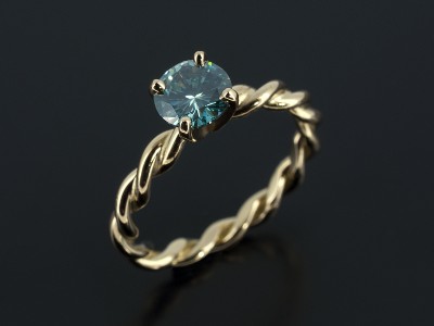 Round Brilliant 0.88ct Blue Diamond in an 18kt Yellow Gold 4 Claw Setting with Rope Detail Band.